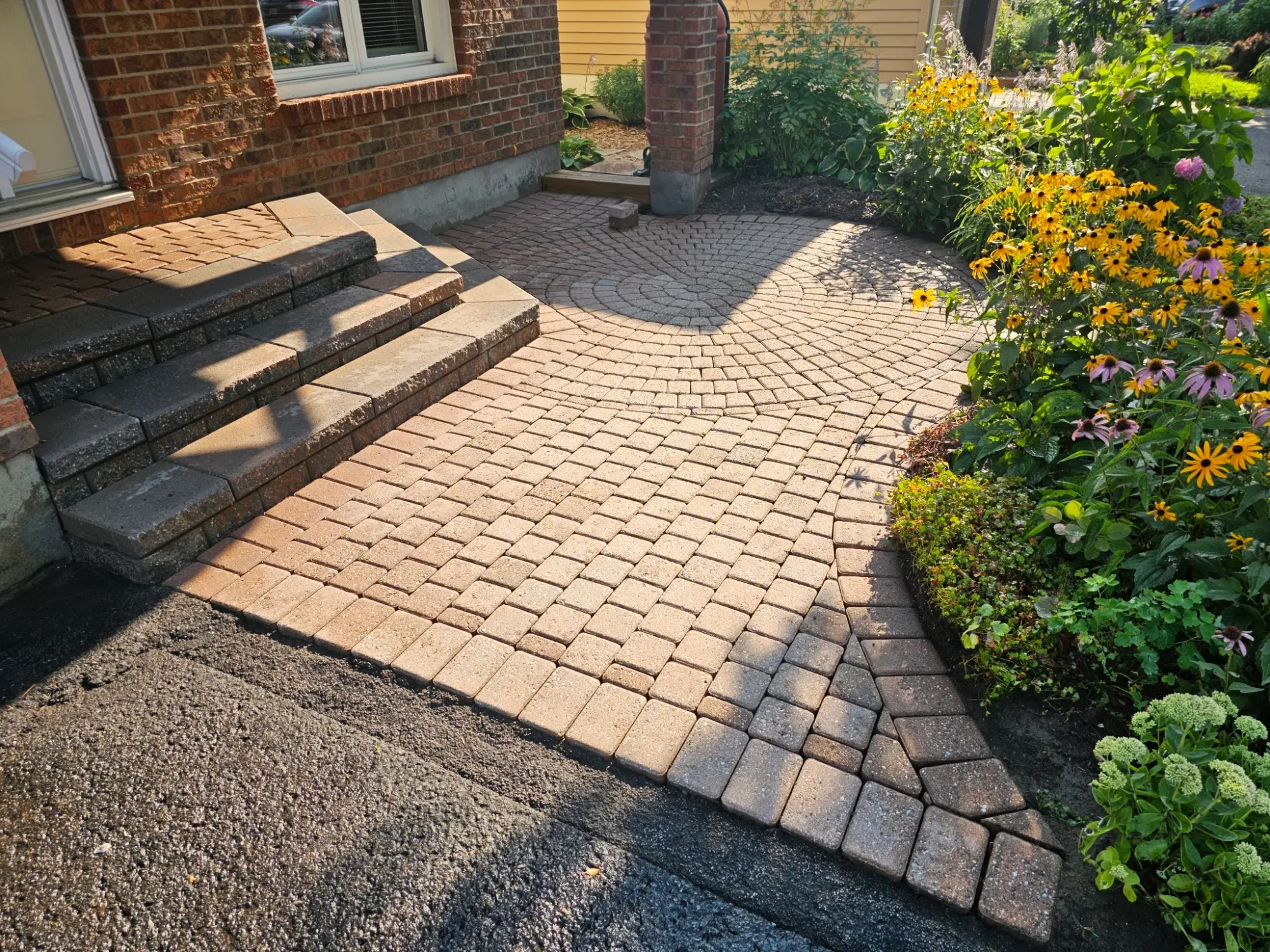 The same front-entry walkway cleaned — joints cleared out and colour revived in evening light