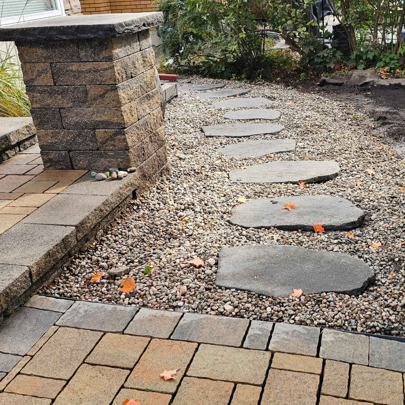 The same path after the clean, the stone washed and raked level around the stepping stones, the steps clear